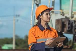 A rail worker stands with a clipboard and does an inspection. Are OSHA and FRSA the same thing?