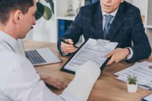 Injured worker meets with lawyer to discuss evidence for proving a FELA railroad injury claim.